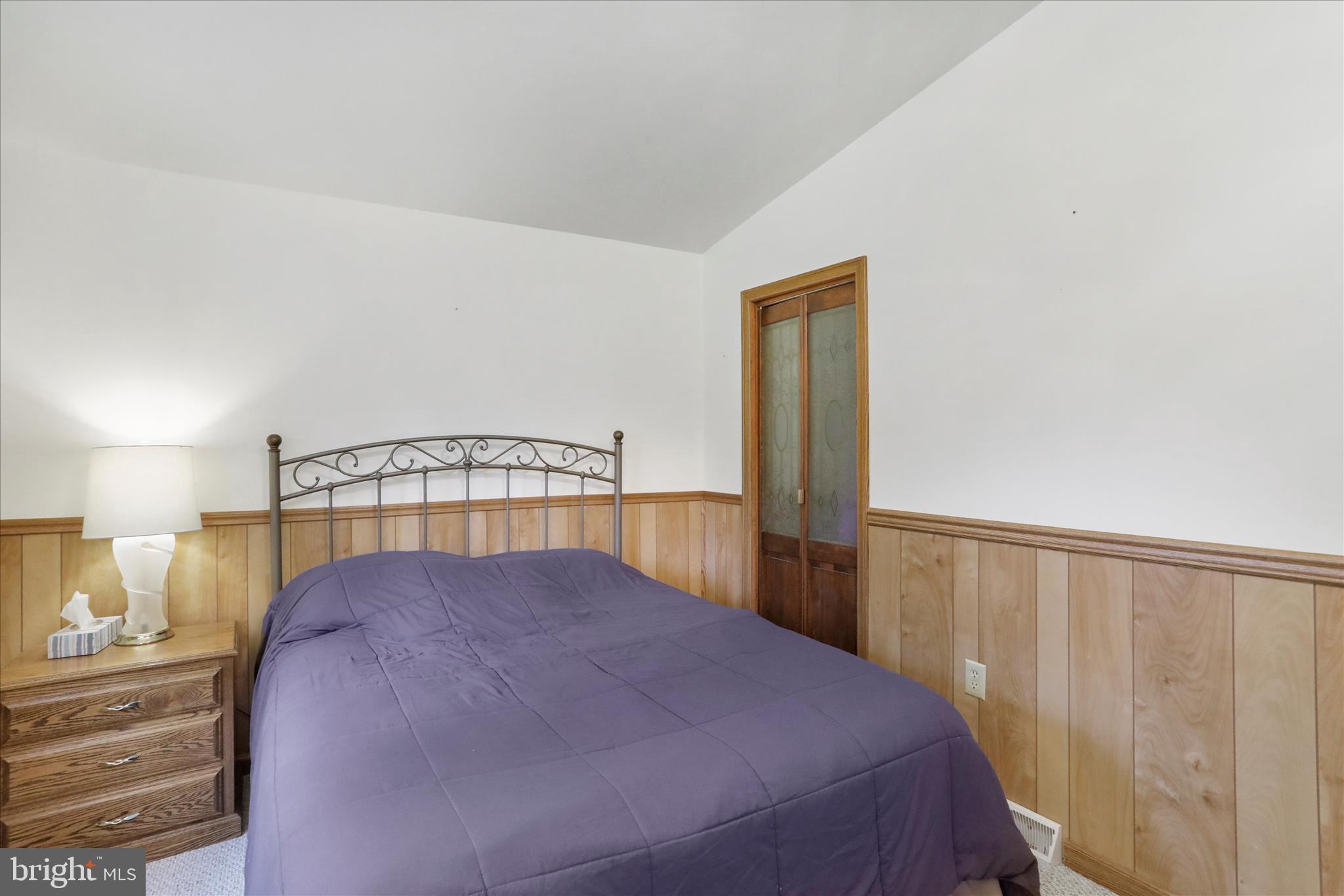 222 Skippers Point Road Oakland, MD 21550 - Photo 24 of 59 a bed sitting in a bedroom next to a window