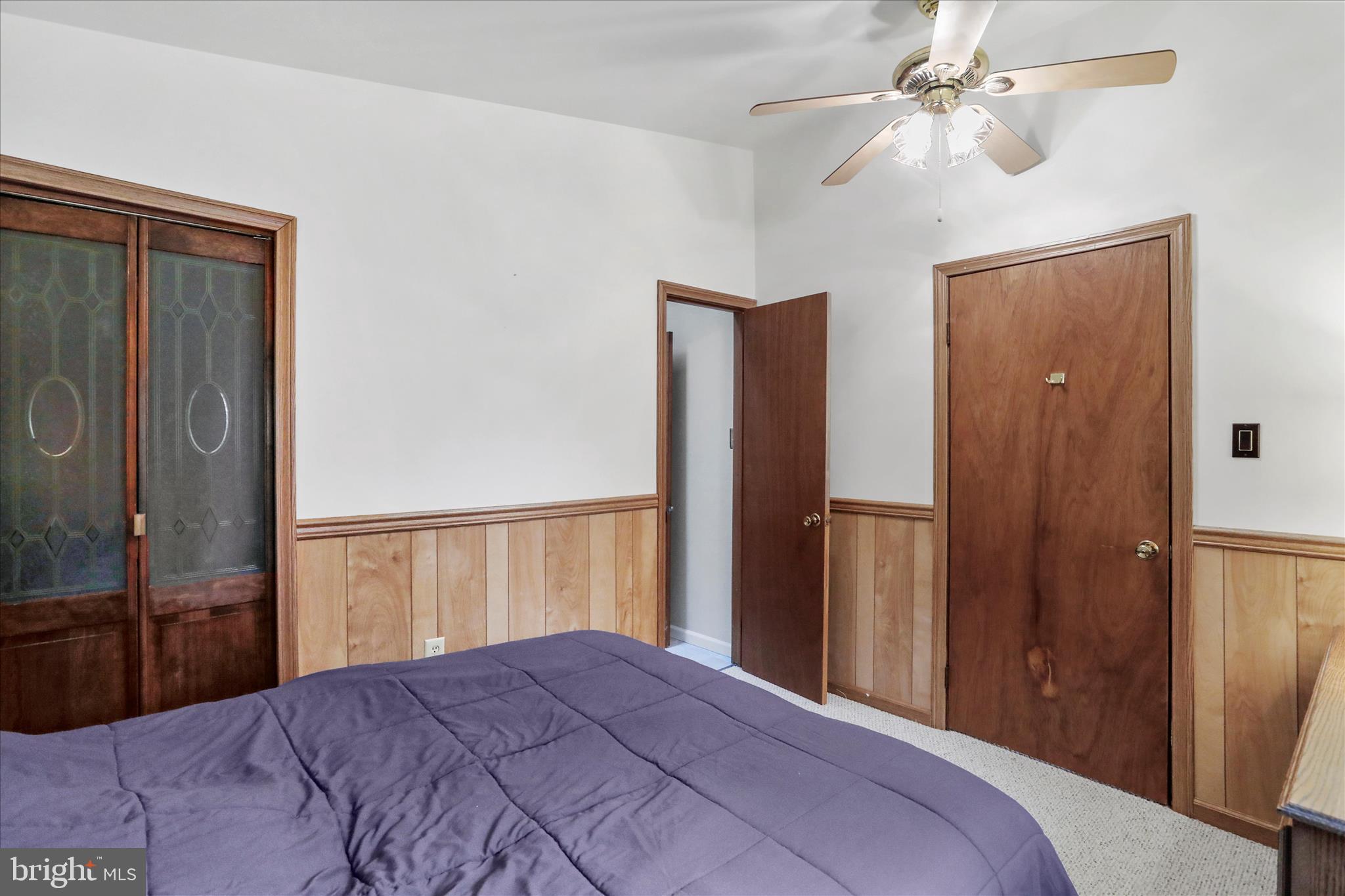 222 Skippers Point Road Oakland, MD 21550 - Photo 25 of 59 a bedroom with a large bed and a chandelier
