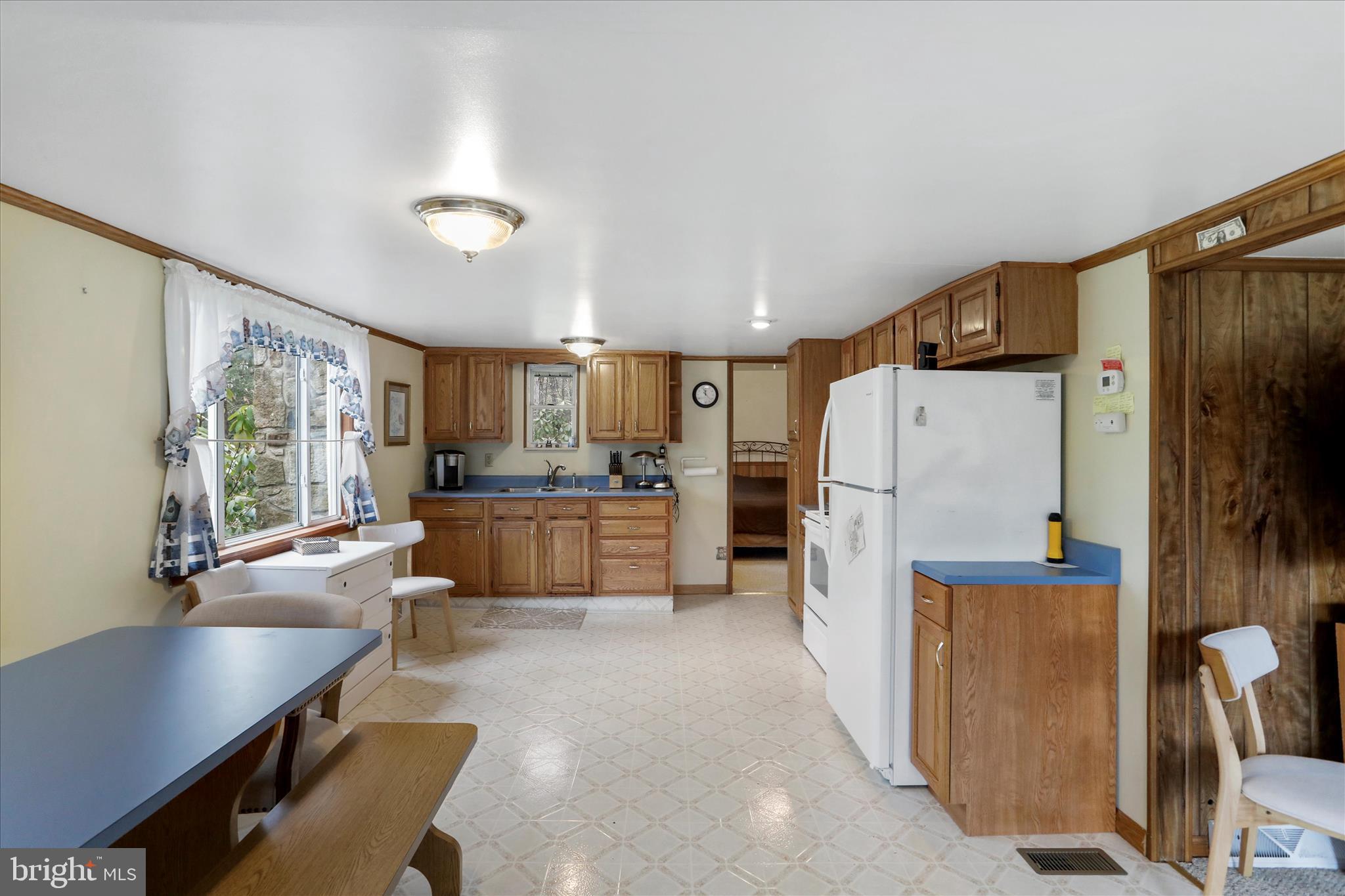 222 Skippers Point Road Oakland, MD 21550 - Photo 9 of 59 a kitchen with refrigerator cabinets and a refrigerator