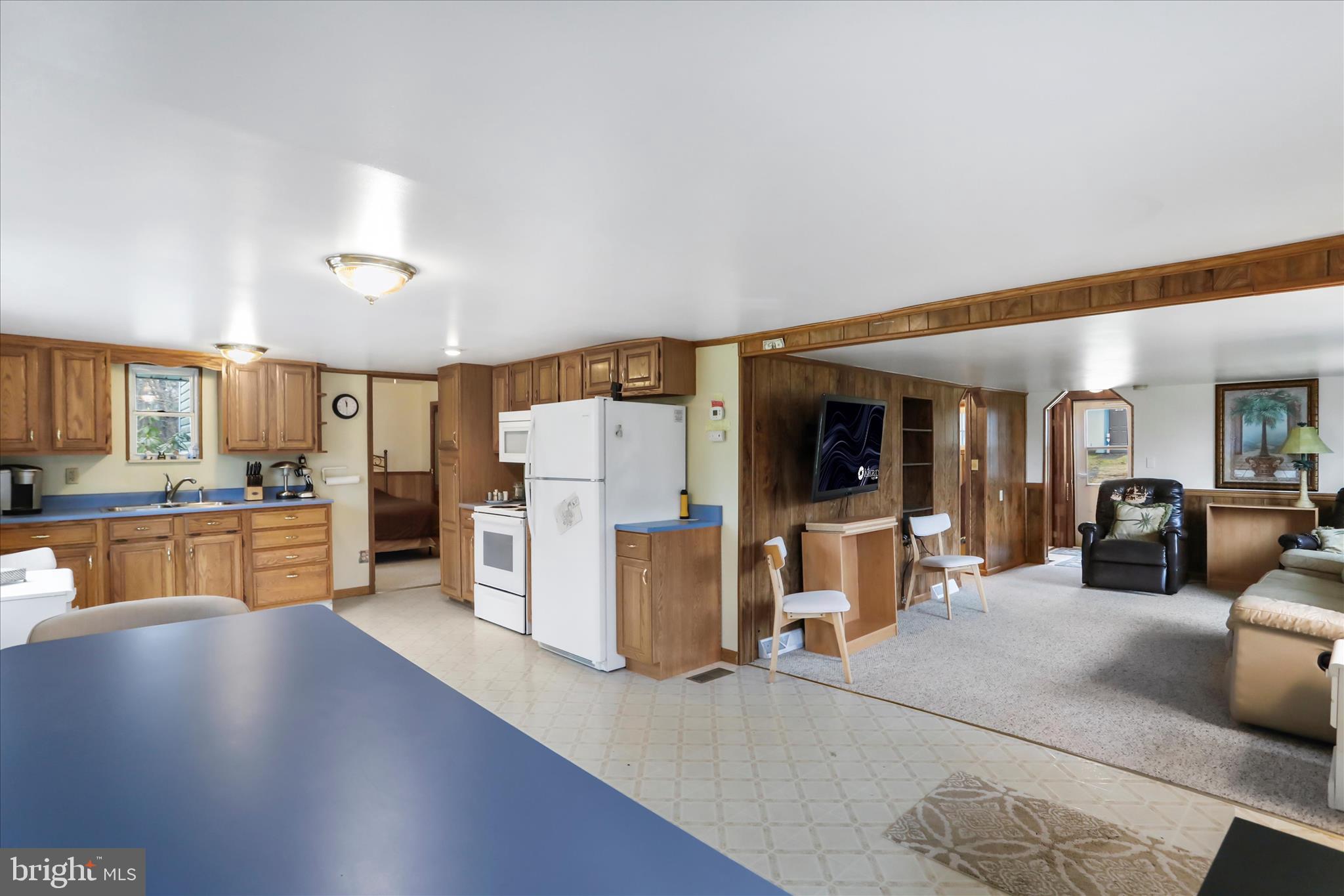 222 Skippers Point Road Oakland, MD 21550 - Photo 10 of 59 a kitchen with stainless steel appliances refrigerator oven dining table and chairs