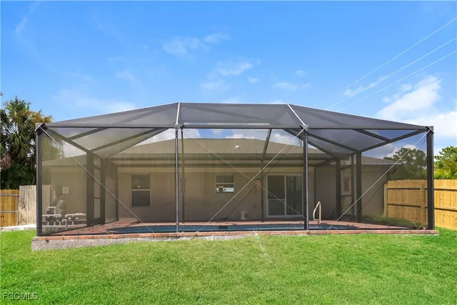a front view of a house with a garden and yard