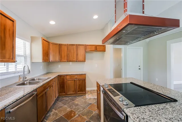 a kitchen that has a sink and a stove