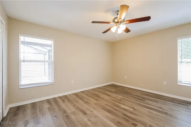 wooden floor in an empty room with a window