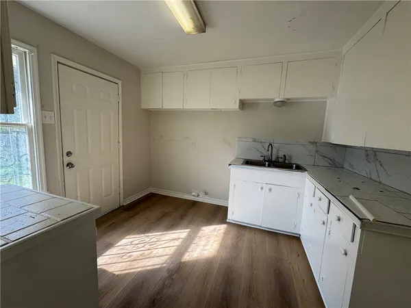 a kitchen with a stove and white cabinets
