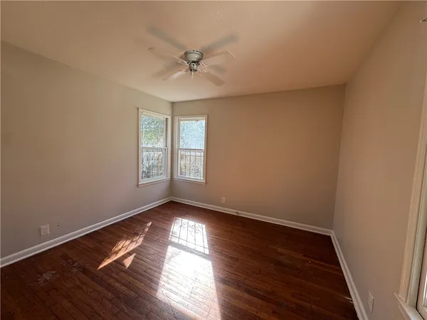 a view of wooden floor and windows in a room