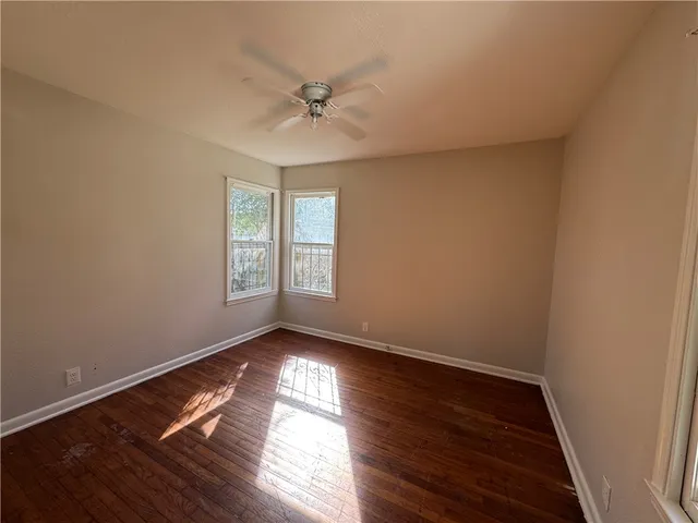 a view of wooden floor and windows in a room
