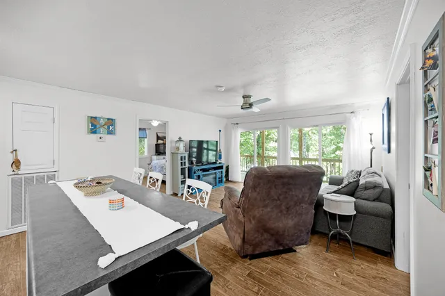 a living room with furniture and a floor to ceiling window