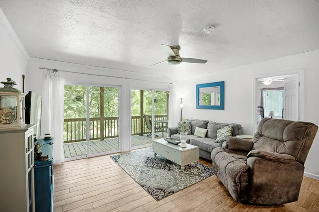 a living room with furniture and kitchen view