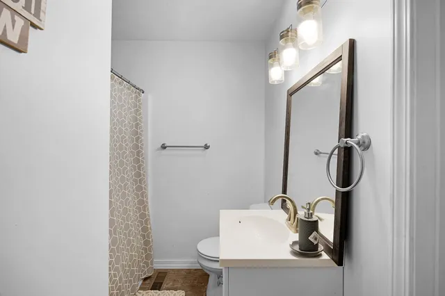 a bed room with a bed mirror and a window