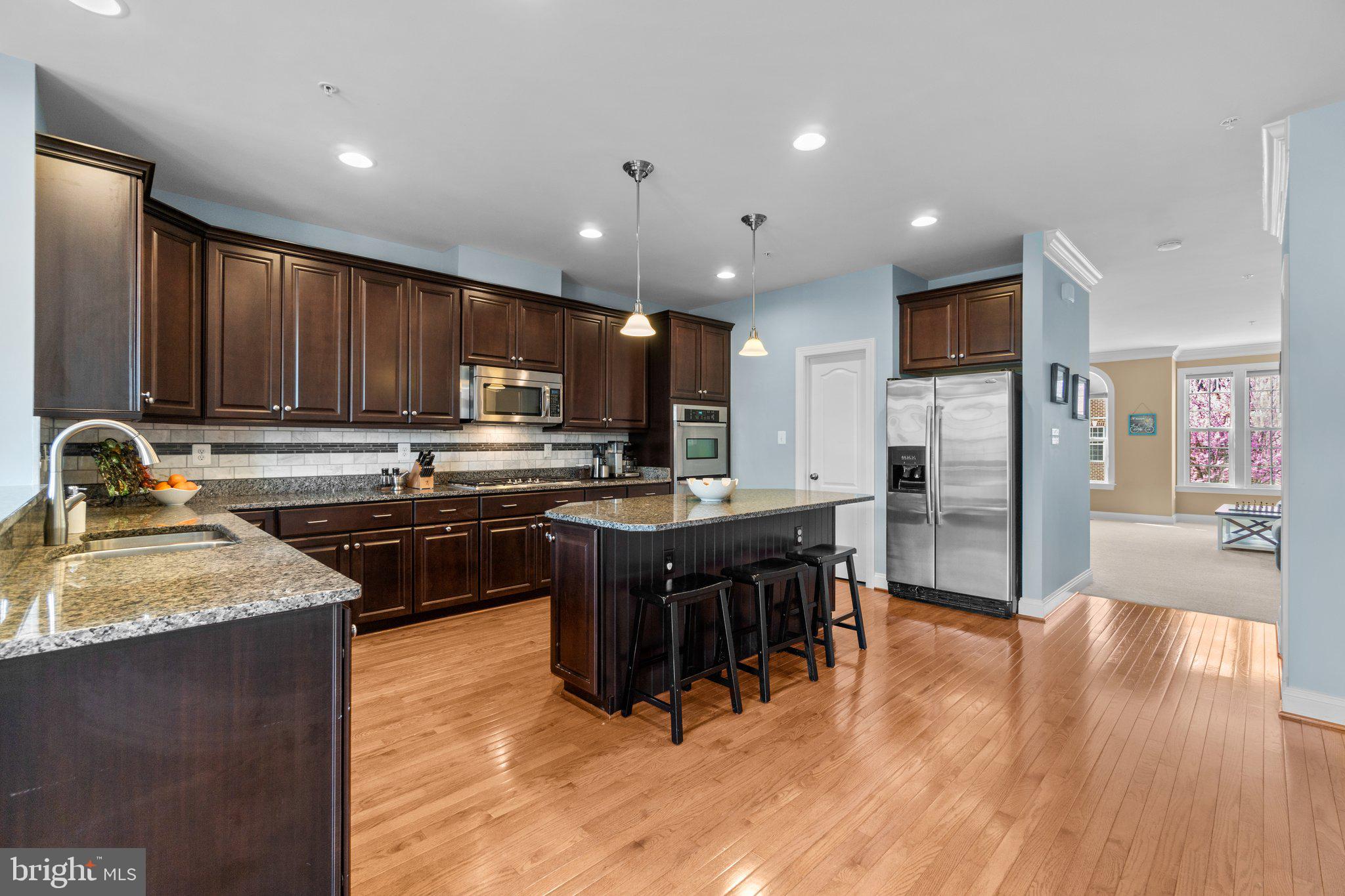9644 Bothwell Lane Frederick, MD 21704 - Photo 12 of 68 a kitchen with stainless steel appliances granite countertop a refrigerator a sink dishwasher a stove and a oven with wooden floor