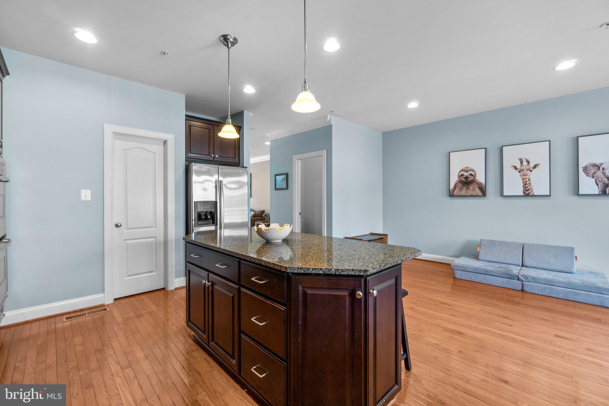9644 Bothwell Lane Frederick, MD 21704 - Photo 14 of 68 a kitchen with granite countertop a sink cabinets and wooden floor