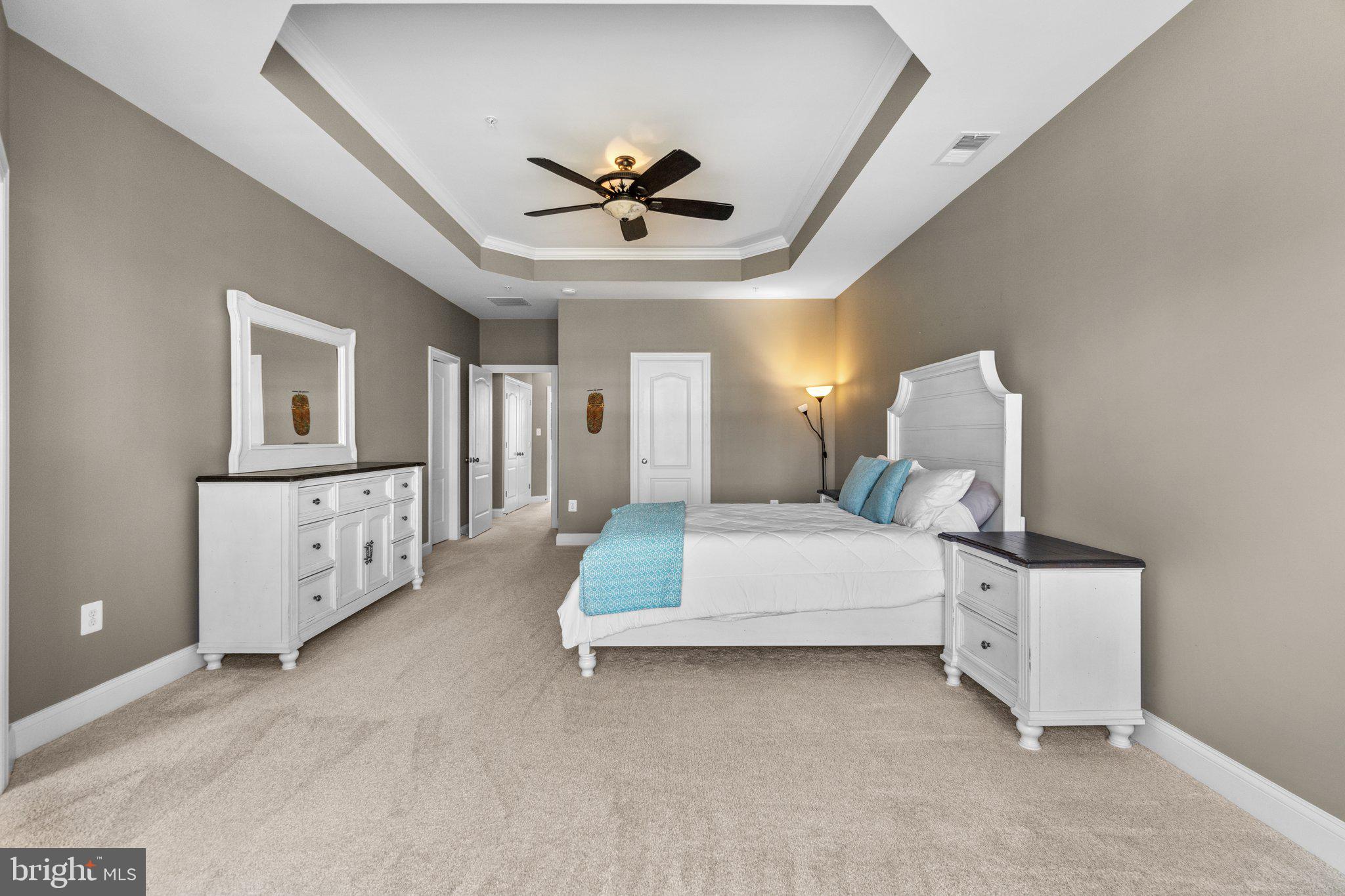 9644 Bothwell Lane Frederick, MD 21704 - Photo 26 of 68 a spacious bedroom with a large bed and ceiling fan