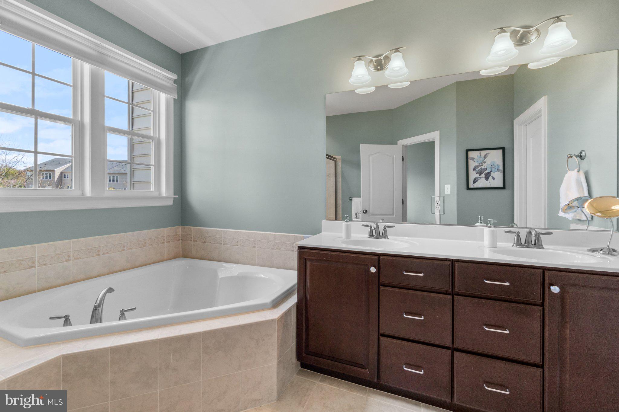 9644 Bothwell Lane Frederick, MD 21704 - Photo 28 of 68 a bathroom with a tub sink double vanity granite and a sink