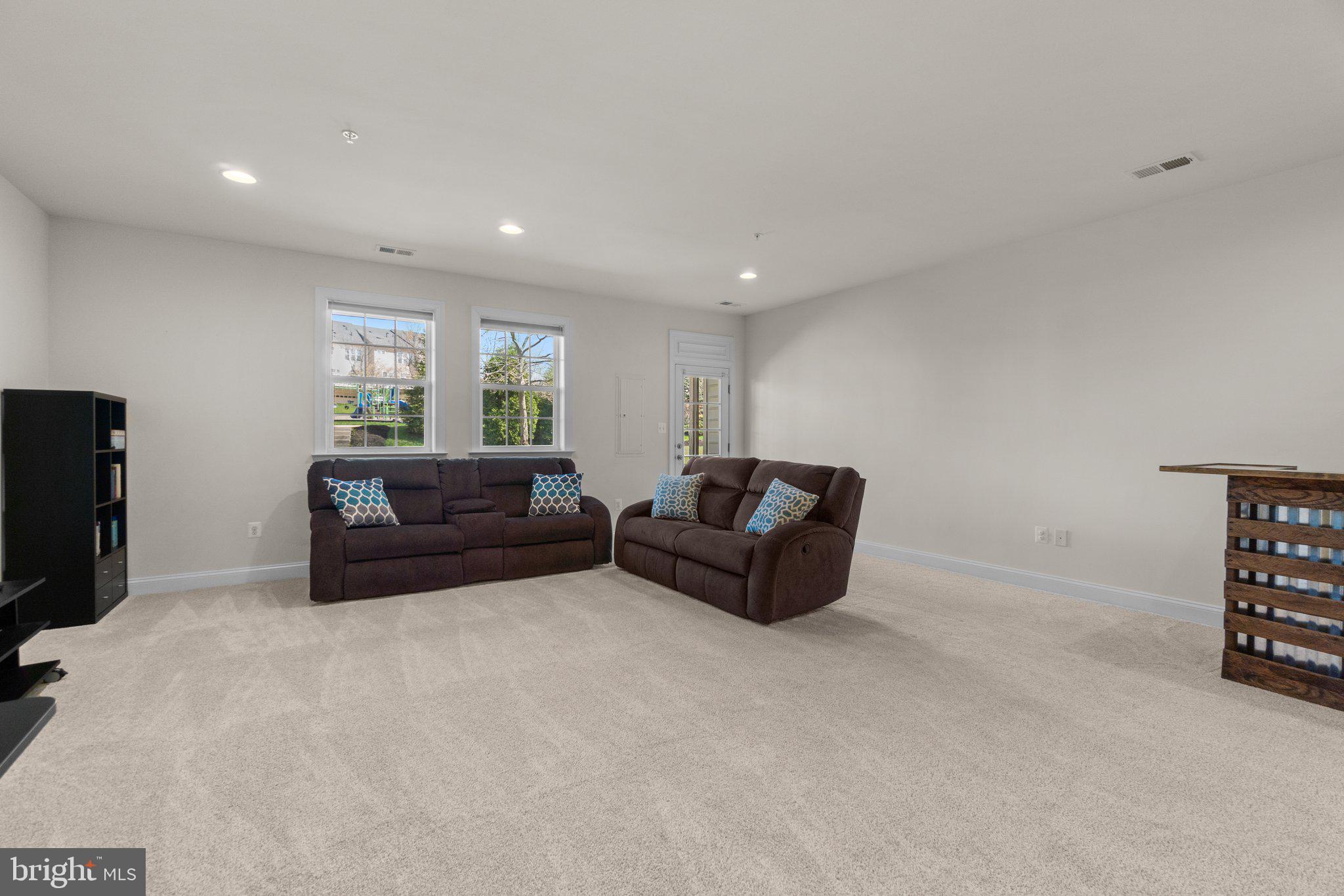 9644 Bothwell Lane Frederick, MD 21704 - Photo 41 of 68 a living room with furniture a flat screen tv and a window