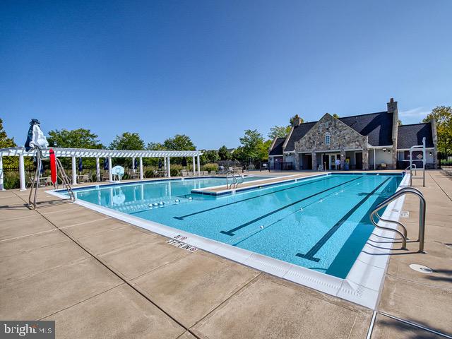 9644 Bothwell Lane Frederick, MD 21704 - Photo 58 of 68 a view of swimming pool with lounge chair and dinning table under an umbrella