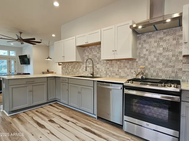 a kitchen with a stove oven and white cabinets