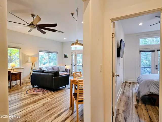 a living room with furniture and a wooden floor
