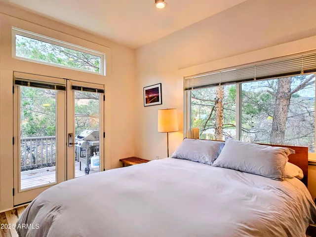 a bedroom with a large bed and a large window