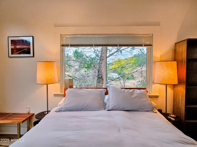 a bedroom with a bed and a window