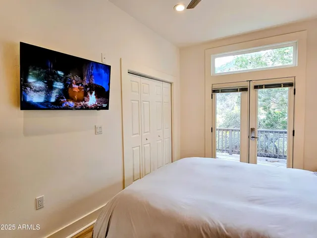 a bedroom with a bed and wall painting