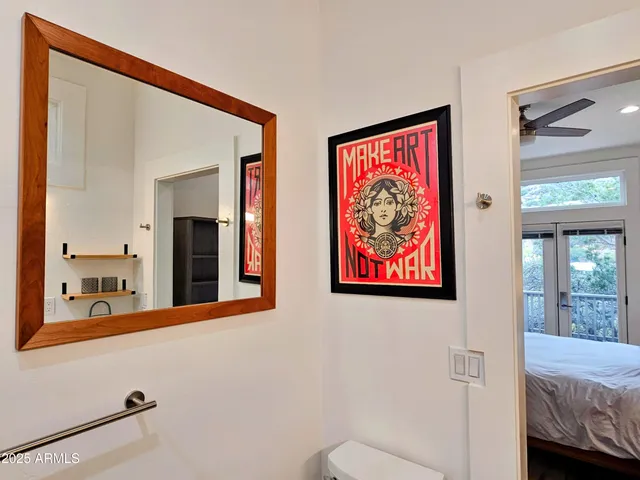 a bedroom with a bed and a painting on the wall