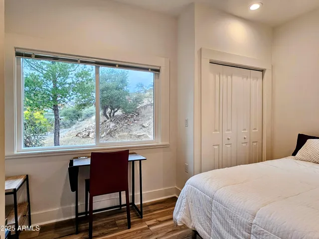 a bedroom with a bed and a window