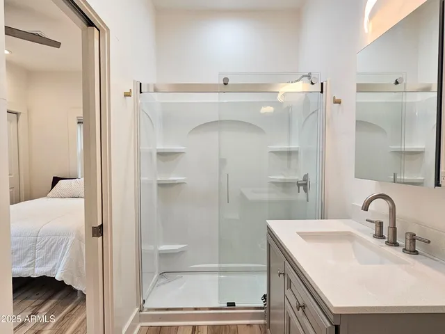 a bathroom with a sink toilet and shower