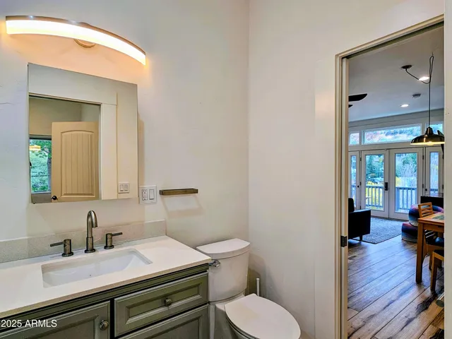 a view of bathroom with a sink and a mirror