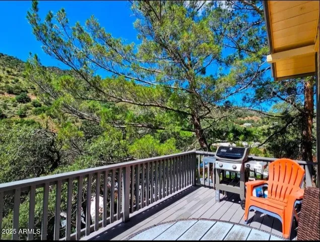 a balcony with wooden floor and outdoor seating