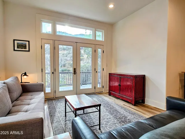 a living room with furniture a large window