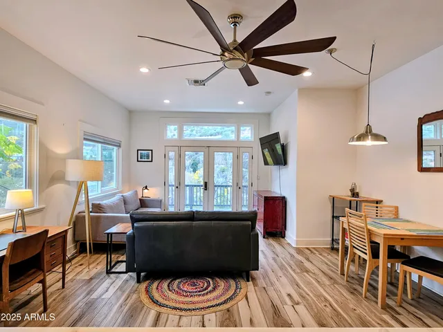 a living room with furniture and a wooden floor