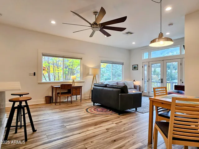 a living room with furniture and a wooden floor
