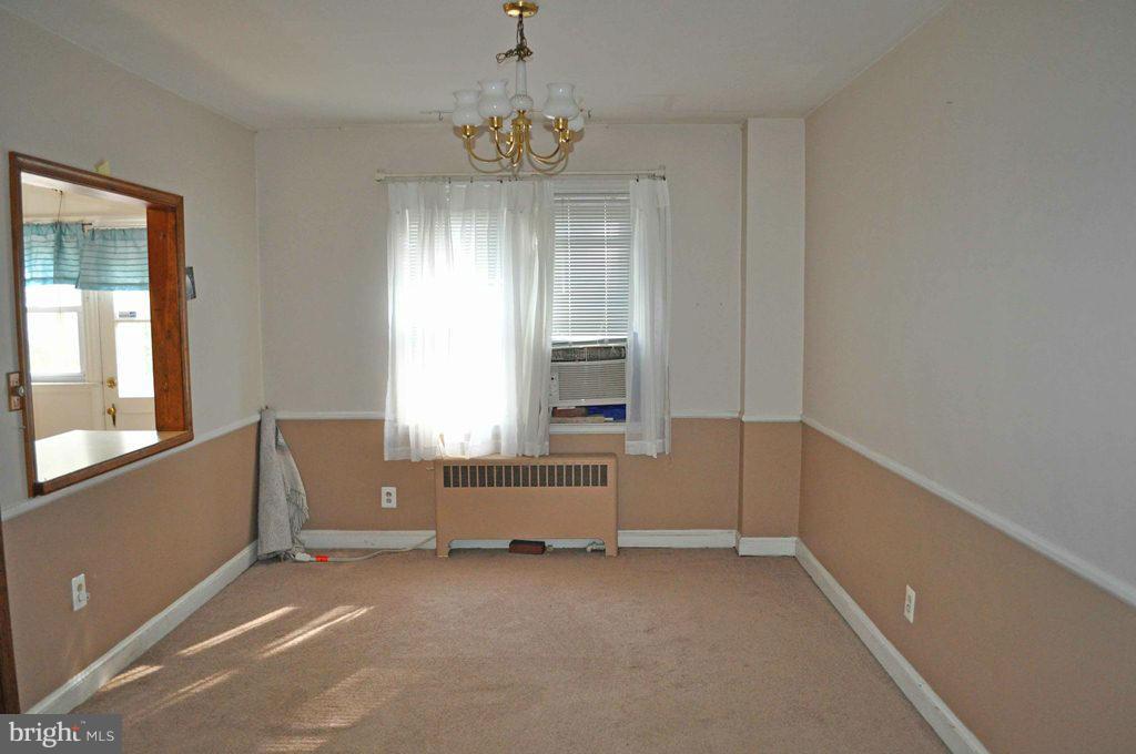 121 Cherrydell Road Catonsville, MD 21228 - Photo 6 of 20 wooden floor and window in an empty room
