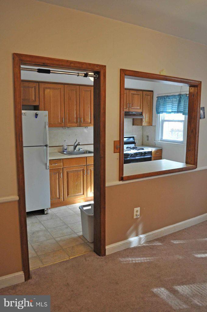 121 Cherrydell Road Catonsville, MD 21228 - Photo 9 of 20 a kitchen with a refrigerator and a sink