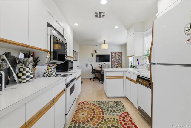 a kitchen with a sink appliances and cabinets