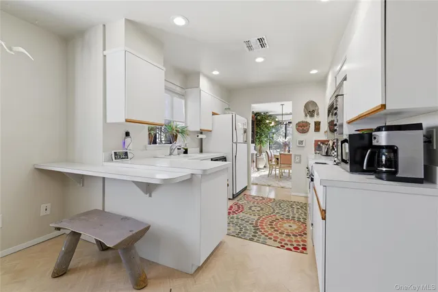 a living room with furniture a fireplace and a sink