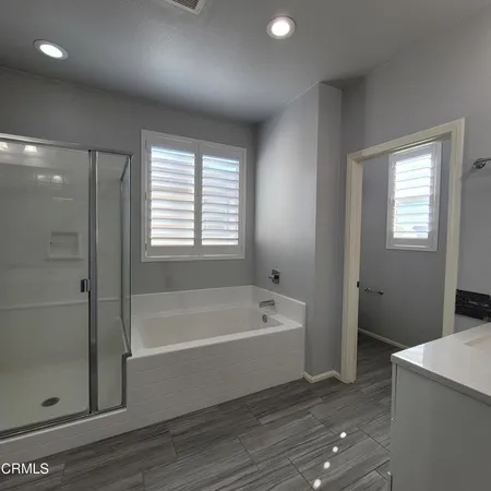 a bathroom with a tub a sink and a shower