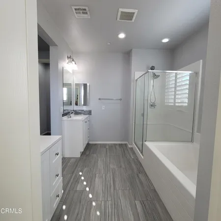 a bathroom with a sink a mirror and a bathtub
