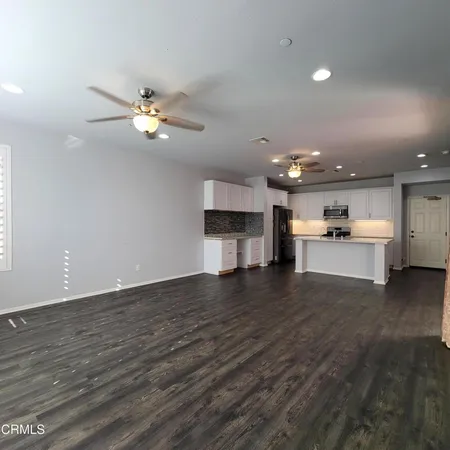 a view of a kitchen with a sink and a fireplace