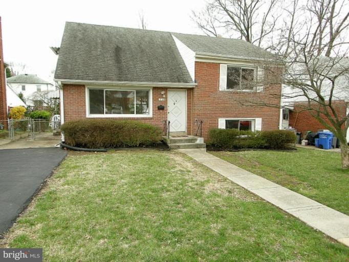 708 Stirling Road Silver Spring, MD 20901 - Photo 4 of 19 a front view of a house with a yard