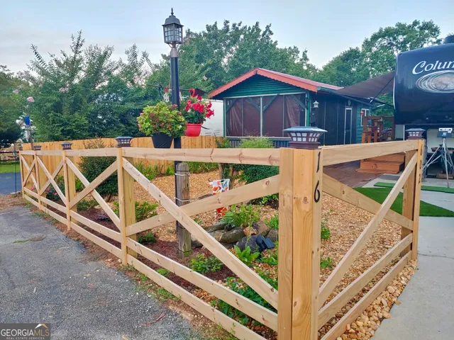 a view of an outdoor sitting area with wooden fence