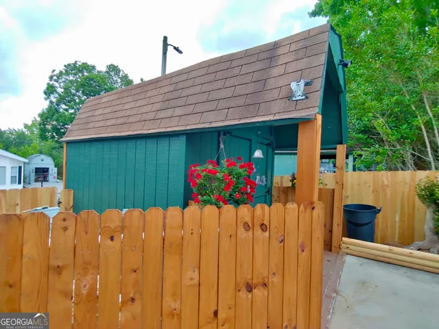 a front view of a house with a wooden fence
