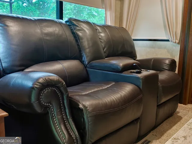a blue couch sitting in a living room next to a window