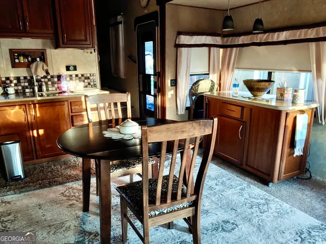 a view of a dining room with furniture and a window