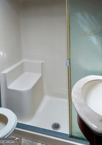 a bathroom with a tub and toilet