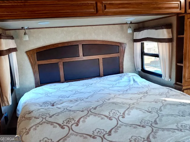 a bedroom with a bed and a large window