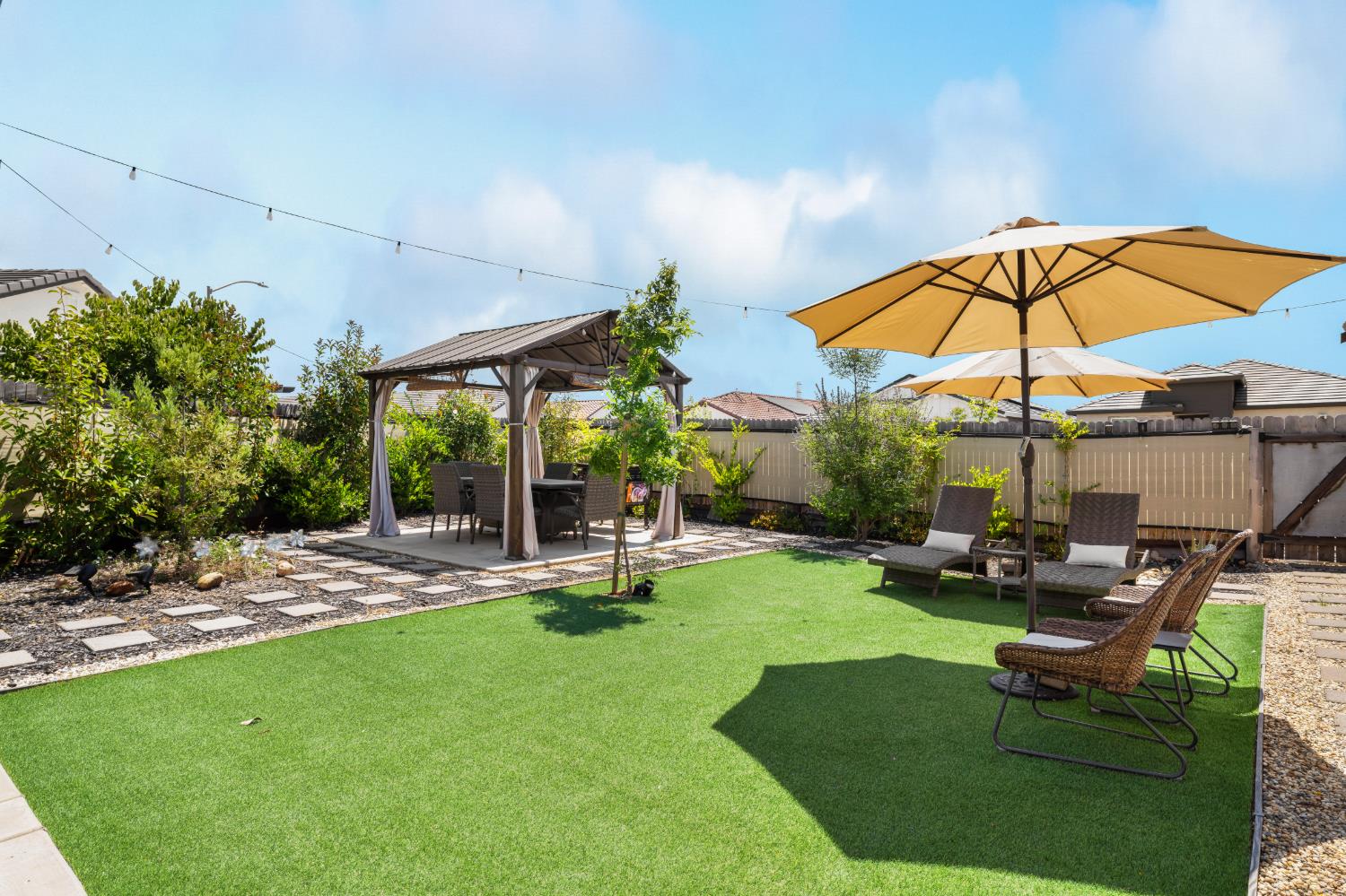 4216 Creede Way Rancho Cordova, CA 95742 - Photo 45 of 56 a view of a backyard with table and chairs under an umbrella