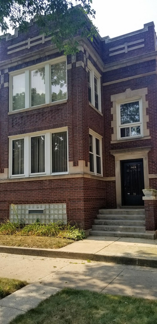 a front view of a house with a garden and swimming pool