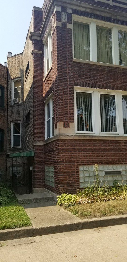7418 South Rhodes Avenue Chicago, IL 60619 - Photo 2 of 41 a view of a brick house with large windows