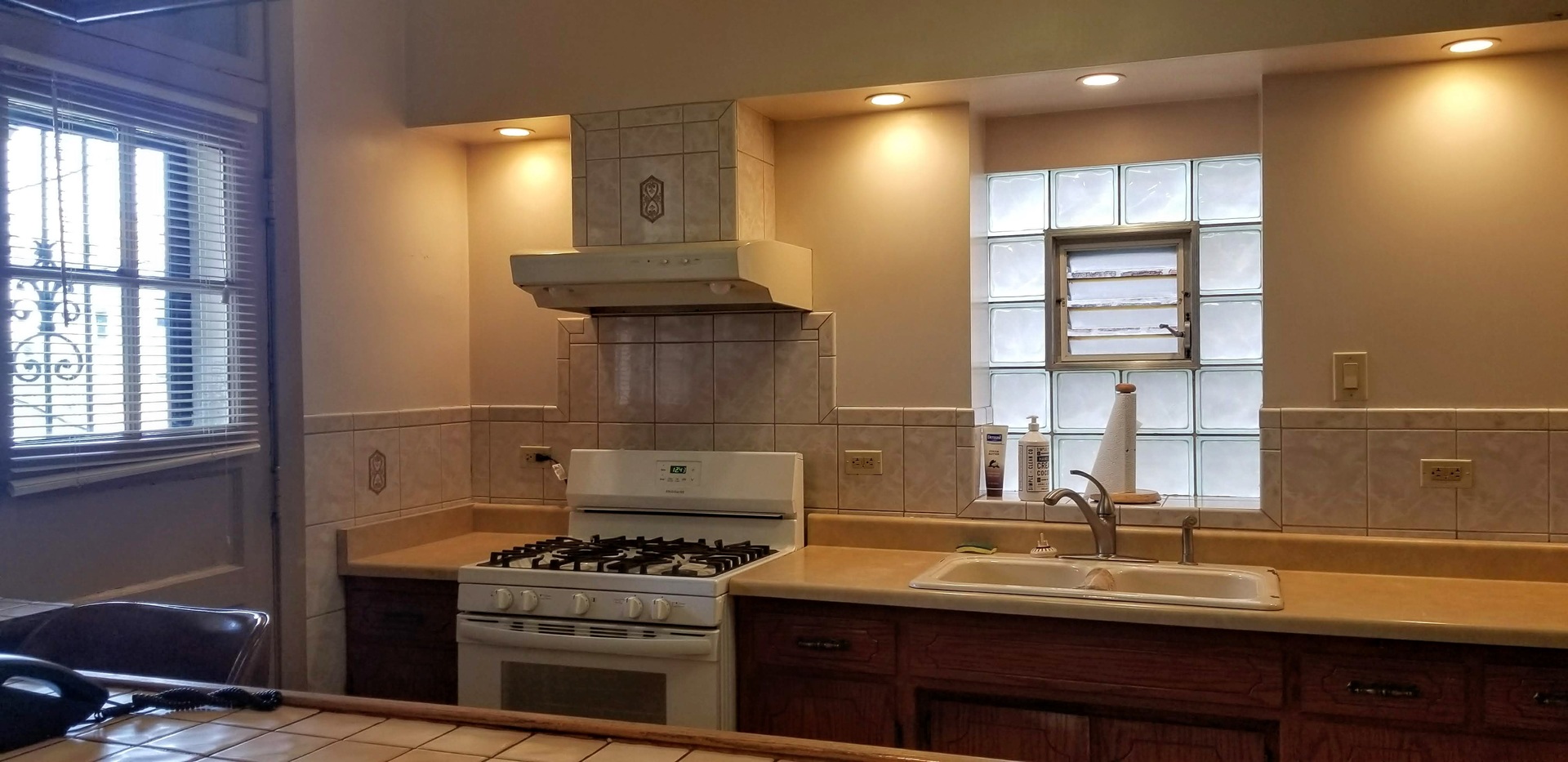 7418 South Rhodes Avenue Chicago, IL 60619 - Photo 18 of 41 a kitchen with a sink and wooden cabinets